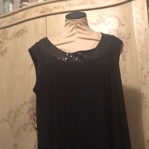 Sleeveless knee length black dress with embellished neck line.